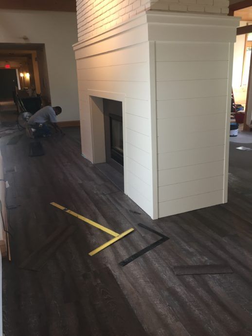 The flooring is being laid around the updated fireplace!